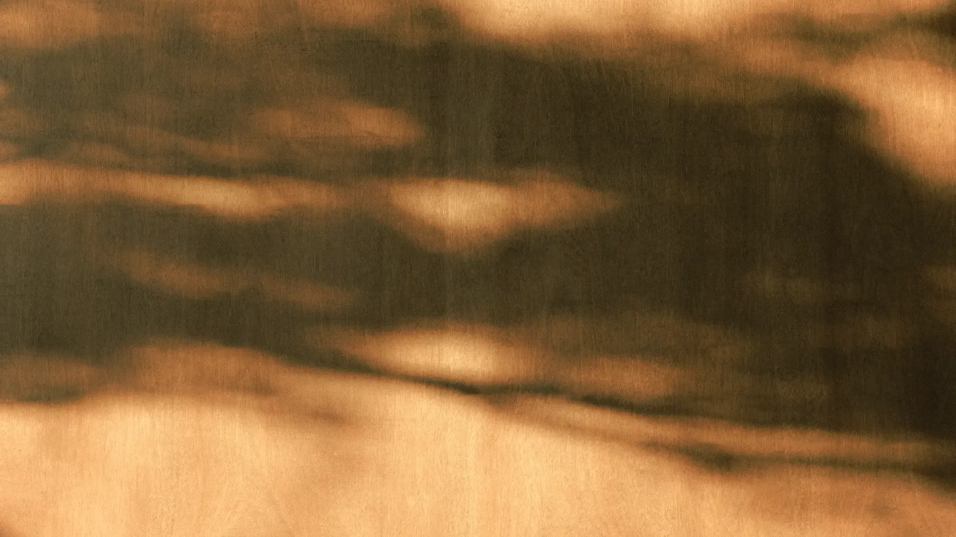 A photo of shadows against a warm background.